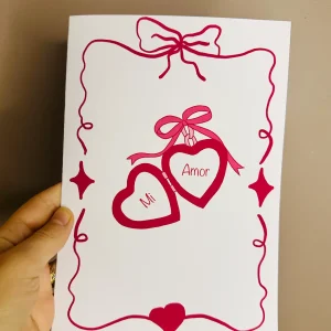 Carte de Saint-Valentin A5 illustrée Mi Amor avec cœurs suspendus et rubans rouges